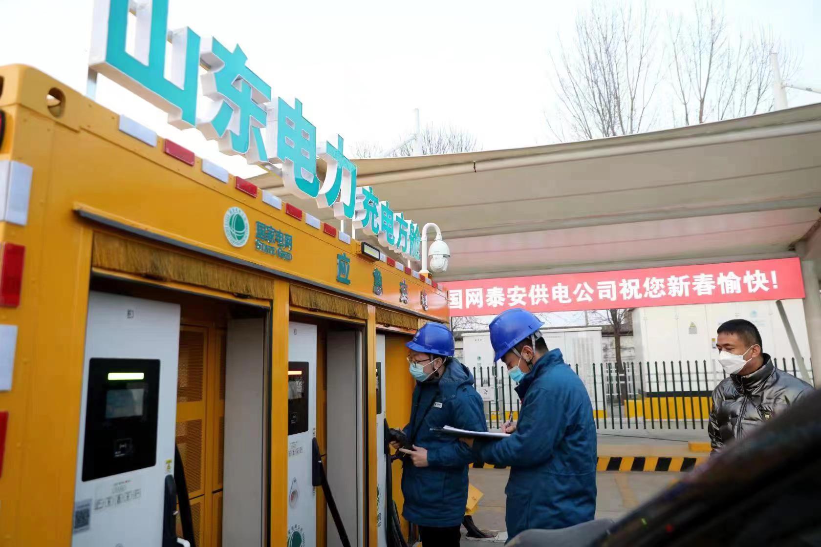 图为国网东平供电公司彩虹共产党员服务队在济广高速东平服务区服务电动汽车车主充电