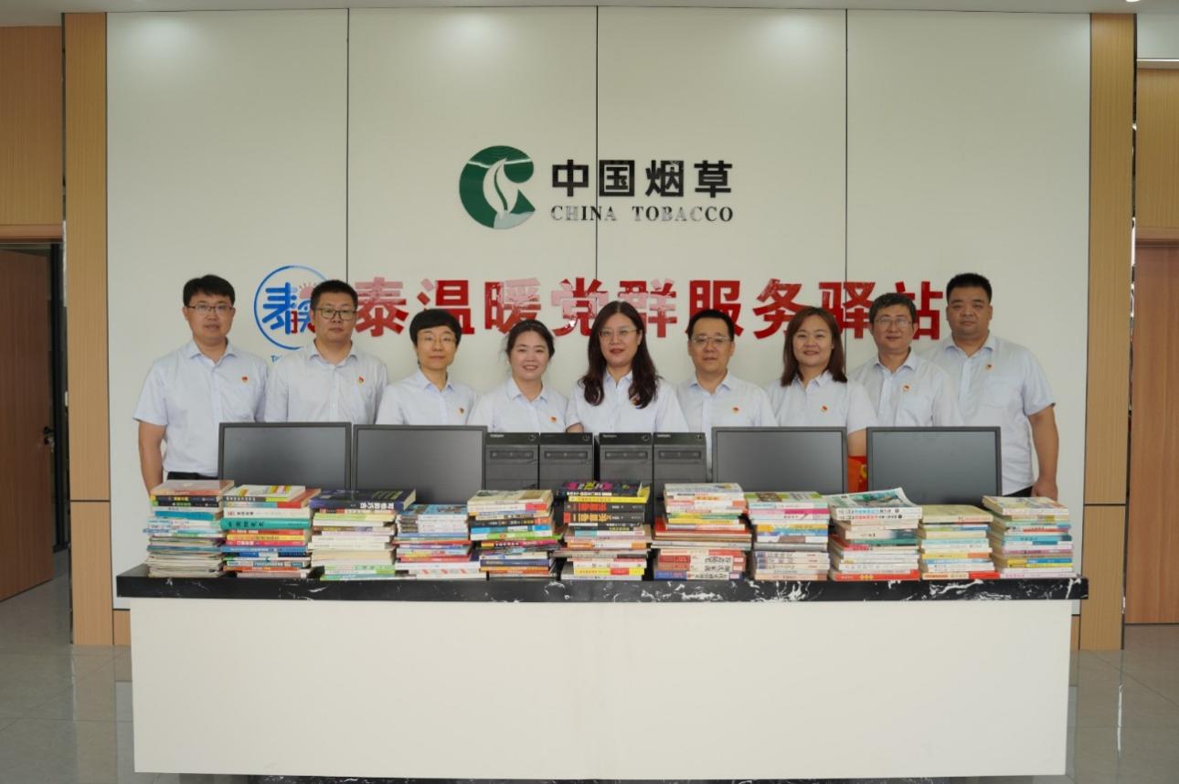 图为泰安烟草党员志愿服务队在新泰羊流镇刘家庄村“泰温暖”党群服务驿站开展捐赠活动