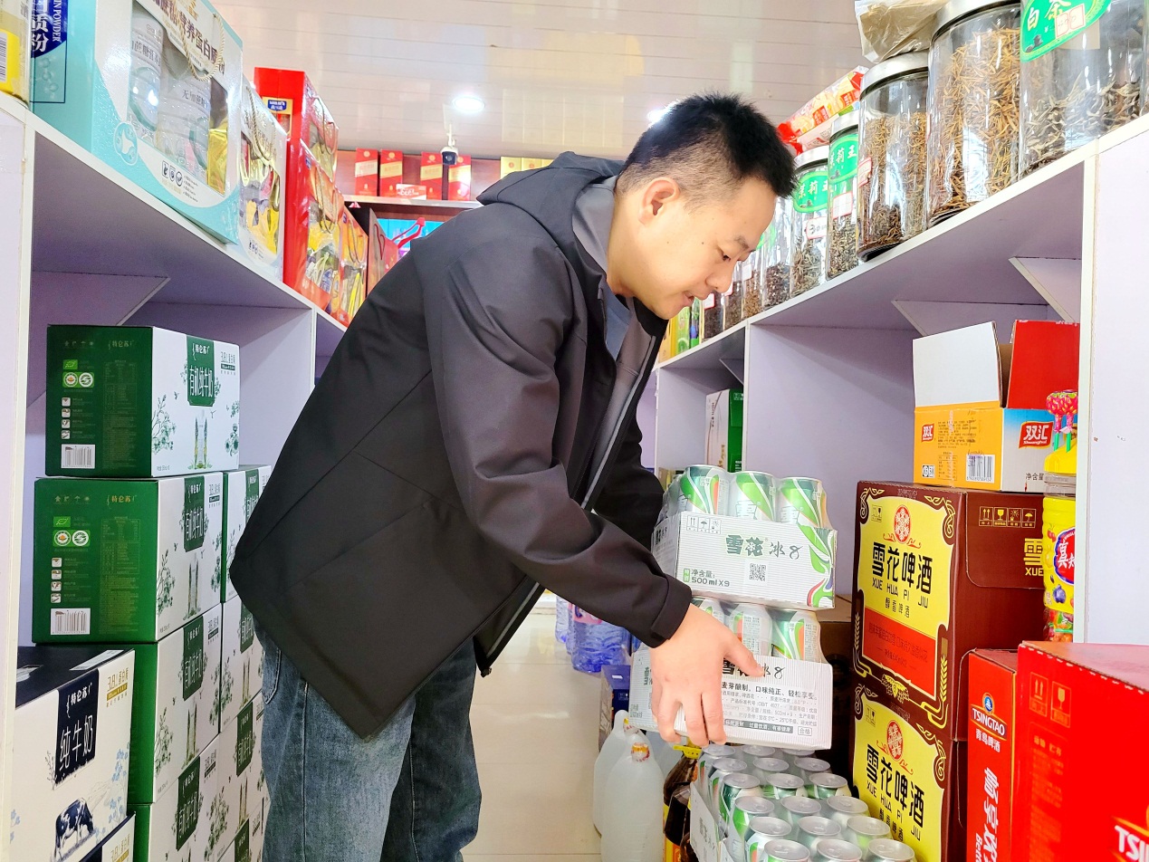 客戶經理劉海濱幫助便民超市整理功能區