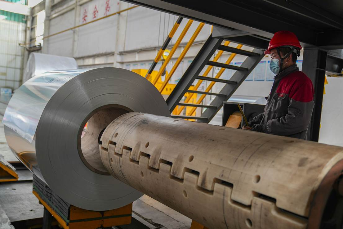 1月7日,山東省鄒平市焦橋鎮的騰鷹凱諾鋁業有限公司工人在鋁板噴涂生產線上忙碌。