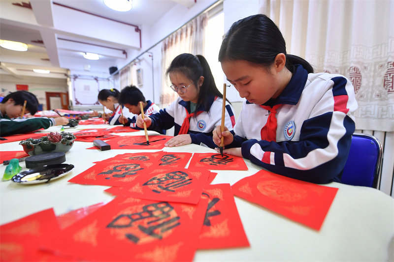 2026年1月29日，在山東省青島市市北區重慶路第三小學舉辦的“萬福迎春”書法活動上，學生們在書寫福字。