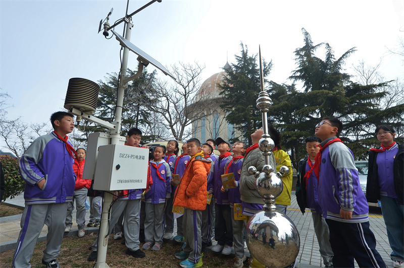 2026年3月21日,在山东省青岛市市北区普新小学开展的气象科普主题研学活动上,学生们参观自动气象设备。王海滨摄