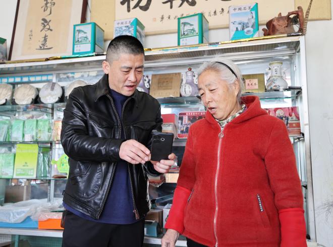 客户经理朱光明指导零售户杜秀芝建立线上经营群